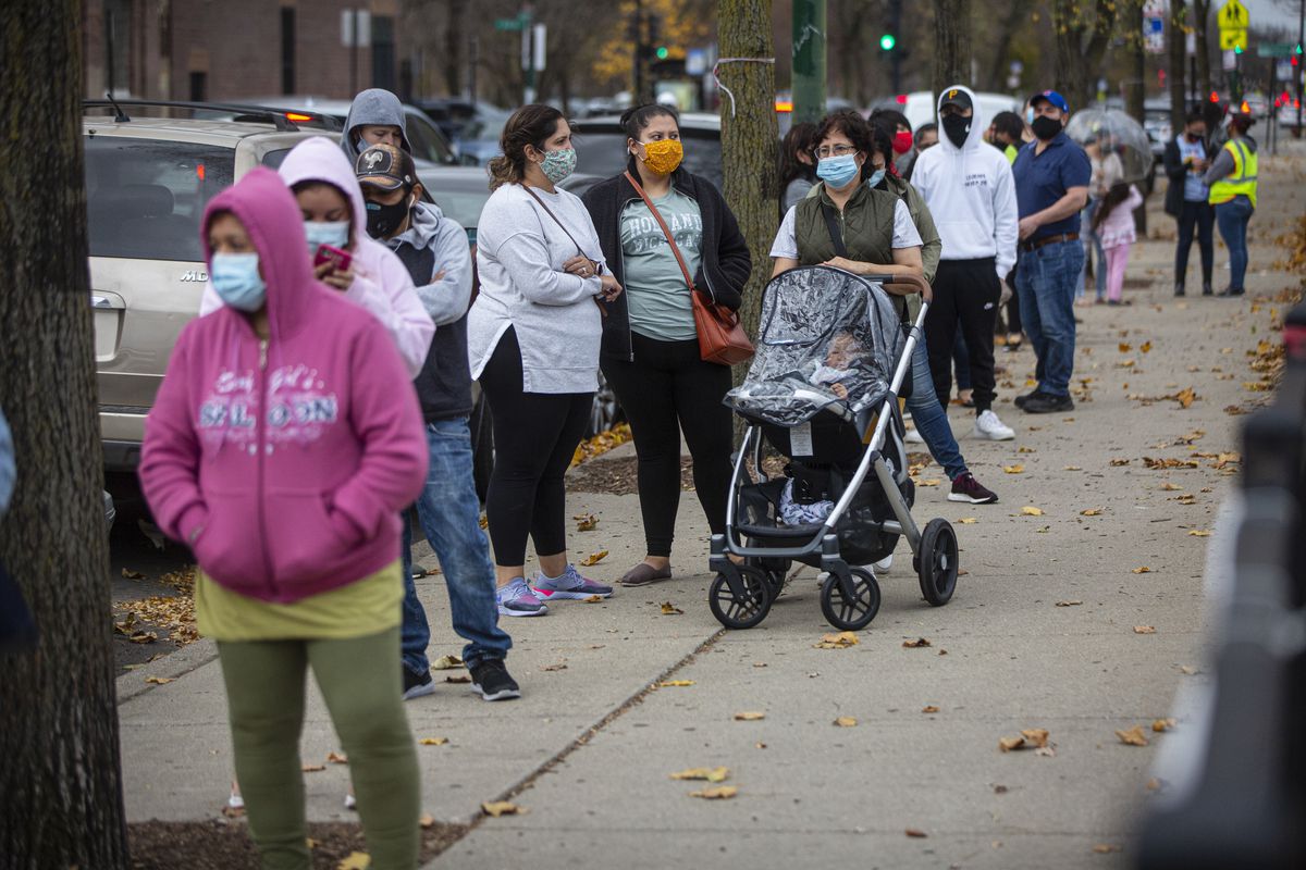 Residents wait in line to get tested at a COVID-19 testing site in November at Maria Saucedo Scholastic Academy. More than a million Illinois residents have been infected throughout the pandemic.