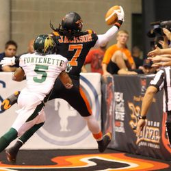 Utah Blaze's Anthony Jackson scores a touchdown as San Jose's Ken Fontenette runs behind him during a football game between the Utah Blaze and the San Jose SaberCats at EnergySolutions Arena in Salt Lake City on Saturday, June 29, 2013.
