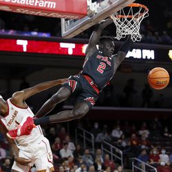 Utah guard Both Gach, right, dunks against Southern California forward Chevez Goodwin during the first half of an NCAA college basketball game in Los Angeles, Wednesday, Dec. 1, 2021. 