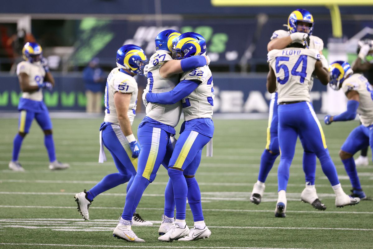 Morgan Fox #97 celebrates with Jordan Fuller #32 of the Los Angeles Rams after a sack on fourth down to secure a win in the NFC Wild Card Playoff game over the Seattle Seahawks at Lumen Field on January 09, 2021 in Seattle, Washington.