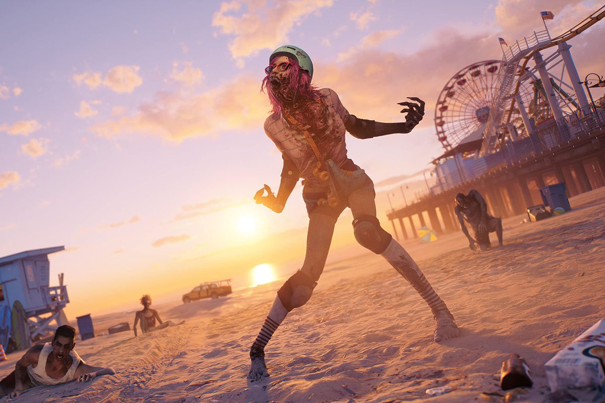 A zombie wearing a helmet and roller skates stands on a beach at the Santa Monica pier in a still from Dead Island 2