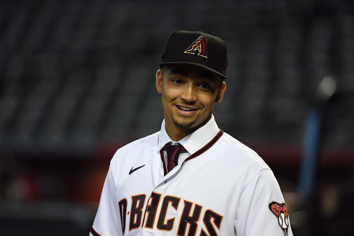 MLB first round draft pick Jordan Lawlar #21 of the Arizona Diamondbacks watches batting practice prior to a game against the Los Angeles Dodgers at Chase Field on July 31, 2021 in Phoenix, Arizona.