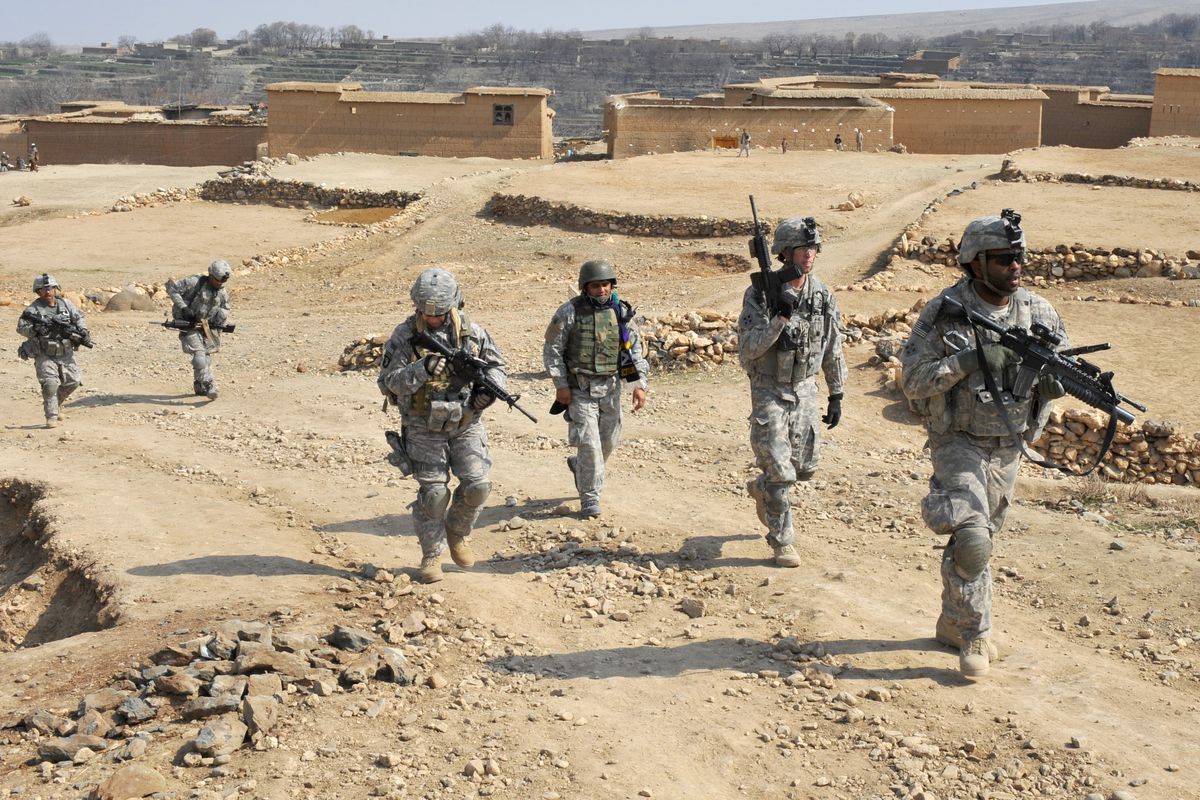 Five US soldiers patrol with an Afghan interpreter