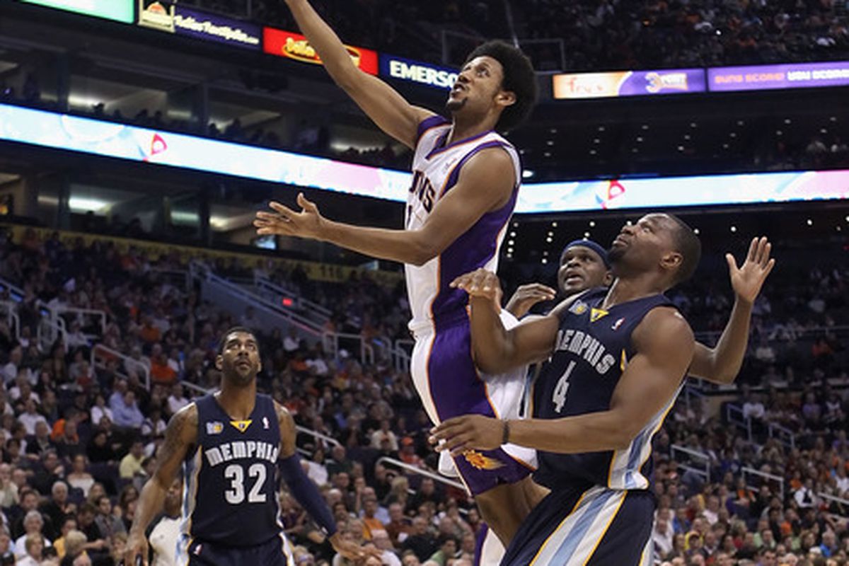 PHOENIX - DECEMBER 08:  Josh Childress #1 of the Phoenix Suns lays up a shot over Sam Young #4 of the Memphis Grizzlies during the NBA game at US Airways Center on December 8 2010 in Phoenix Arizona.  (Photo by Christian Petersen/Getty Images)