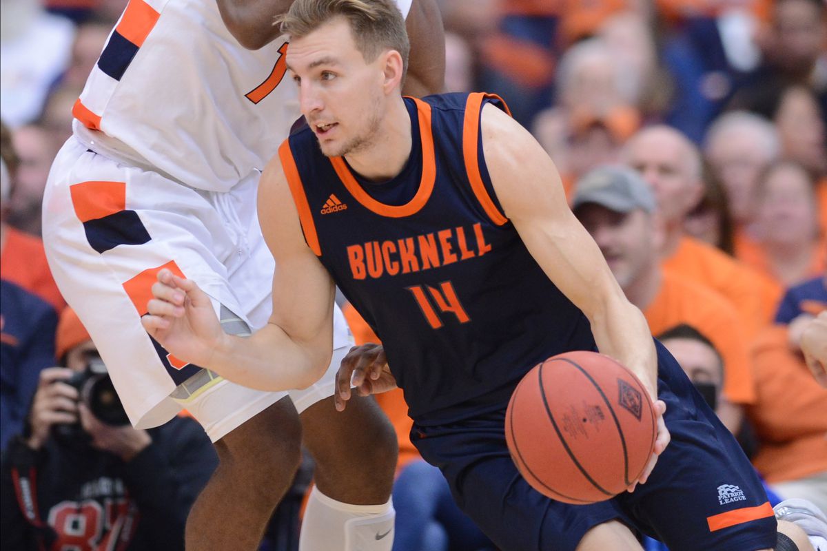 Bucknell Bison guard Jimmy Sotos gets the ball past Syracuse Orange forward Quincy Guerrier in the second half at the Carrier Dome.&nbsp;