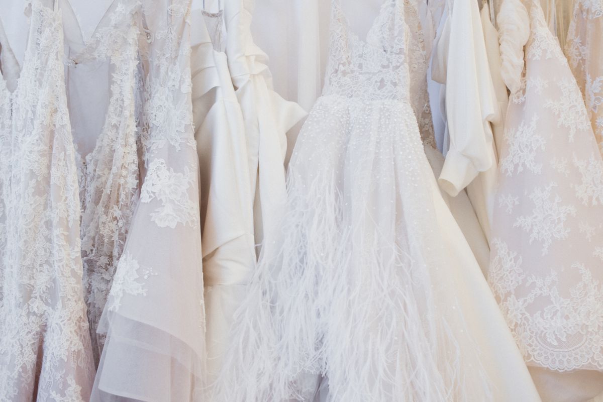 a rack of designer wedding dresses
