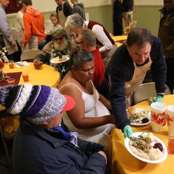 Gov. Gary Herbert serves dinner at the Rescue Mission of Salt Lake at its annual day before Thanksgiving banquet on Wednesday, Nov. 23, 2016.