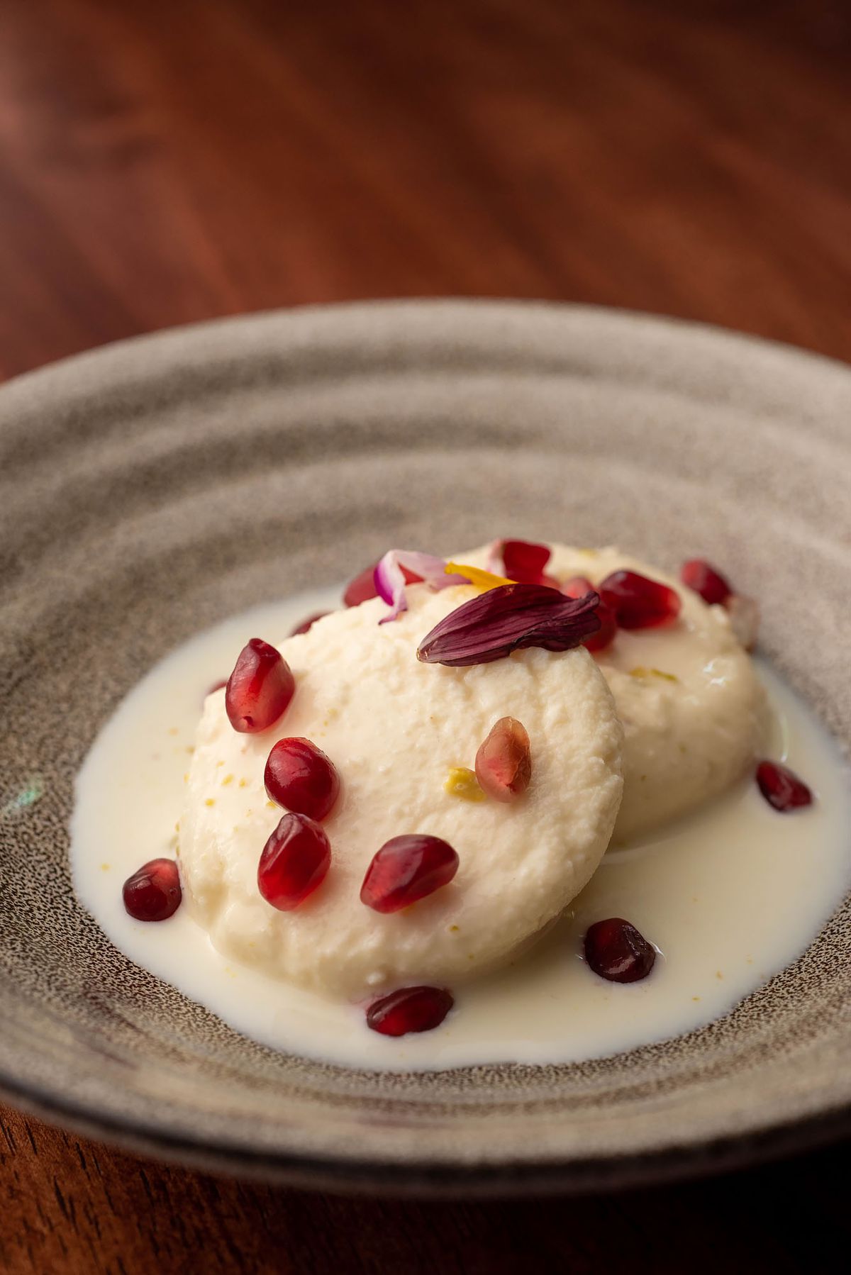 Small white cakes with pomegranate for dessert.