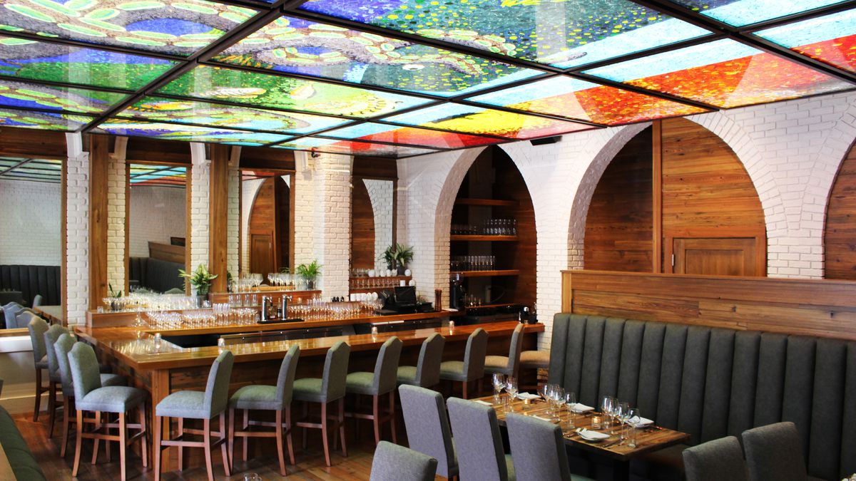 glassed stained ceilings above a dark bar 