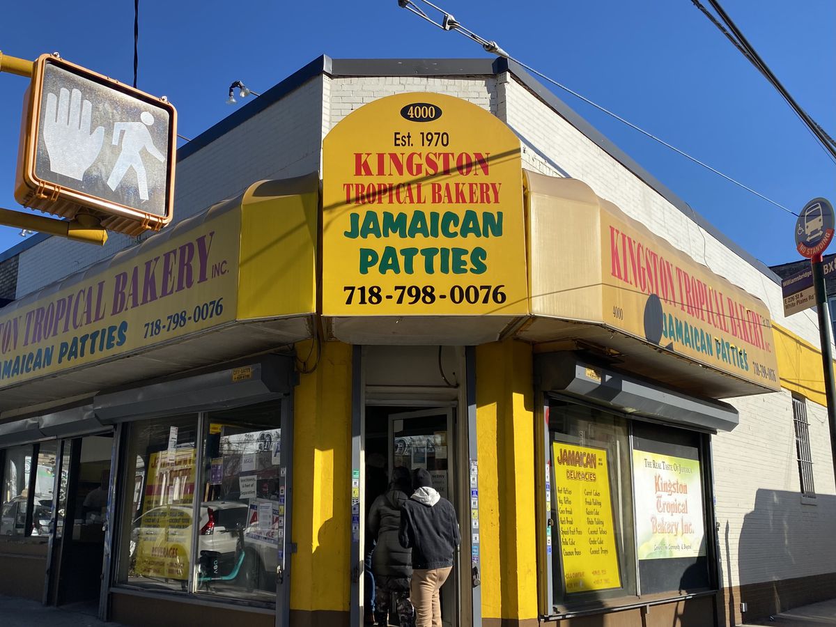 A person enters the front door of Kingston Tropical Bakery, a Jamaican bakery in the Bronx.