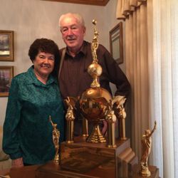 John Hadfield and his wife Kathryn have one of the three trophies won by the Brigham City LDS Fourth Ward when the men's basketball team won the All-Church Tournament.