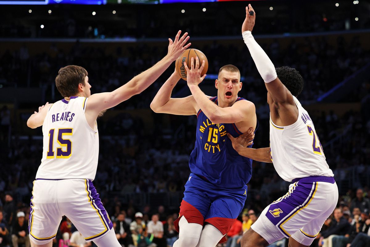 Nikola Jokic #15 of the Denver Nuggets drives to the basket against Austin Reaves #15 of the Los Angeles Lakers and Rui Hachimura #28 of the Los Angeles Lakers during the third quarter in game three of the Western Conference Finals at Crypto.com Arena on May 20, 2023 in Los Angeles, California.