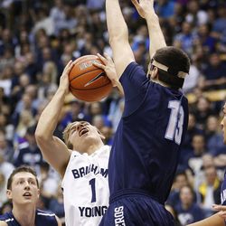 Brigham Young Cougars guard Chase Fischer (1) drives on San Diego Toreros guard Vasa Pusica (13) in Provo Thursday, Feb. 19, 2015. 