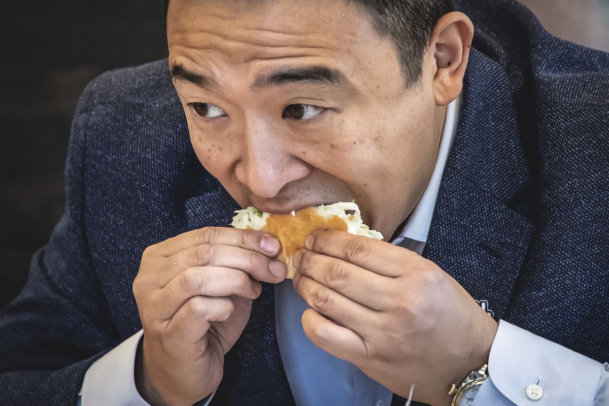 Man bites into a sandwich.