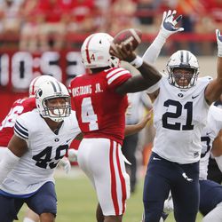 Brigham Young Cougars defensive lineman Moses Kaumatule (49) and Brigham Young Cougars linebacker Harvey Langi (21) pressure Nebraska Cornhuskers quarterback Tommy Armstrong Jr. (4) in Lincoln, Neb., Saturday, Sept. 5, 2015. BYU won 33-28 on a last-second touchdown pass.