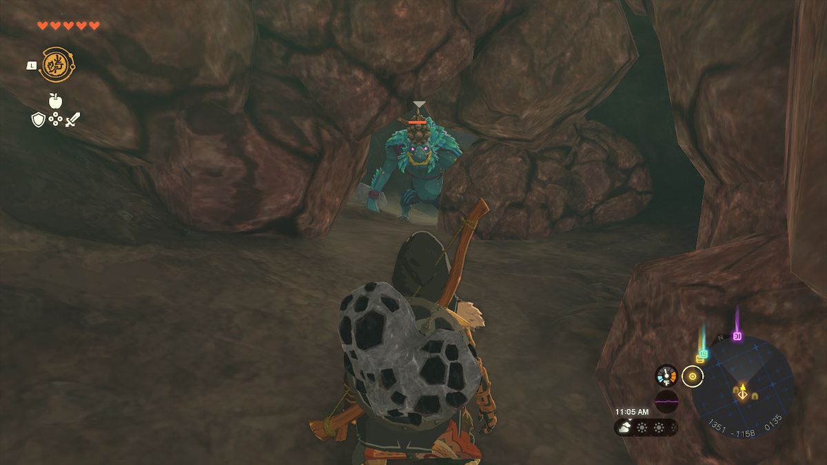 A Blue Horriblin takes a peak at Link from a gap in a rock wall in Zelda: Tears of the Kingdom