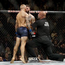 TJ Dillashaw screams in Cody Garbrandt’s face after their UFC 217 fight.