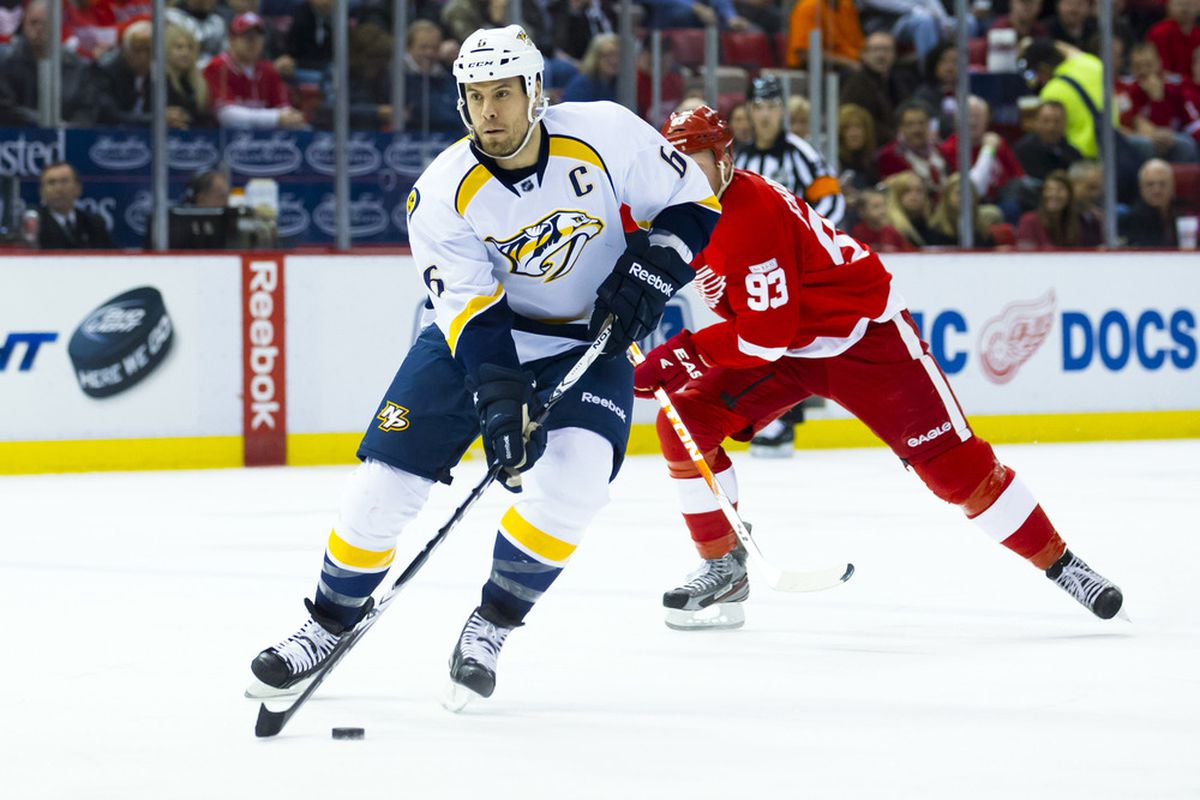 March 30, 2012; Detroit, MI, USA; Nashville Predators defenseman Shea Weber (6) skates with the puck as Detroit Red Wings right wing Johan Franzen (93) defends in the first period at Joe Louis Arena. Mandatory Credit: Rick Osentoski-US PRESSWIRE