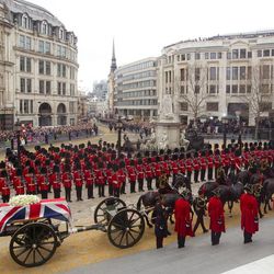 A Union flag draped coffin bearing the body of former British Prime Minister Margaret Thatcher is carried on a gun carriage drawn by the King's Troop Royal Artillery during her ceremonial funeral procession in London, Wednesday, April 17, 2013. A coffin containing the body of former Prime Minister Margaret Thatcher was driven Wednesday from the Houses of Parliament to the church of St. Clement Danes for prayers ahead of the former leader's full funeral at St. Paul's Cathedral. 