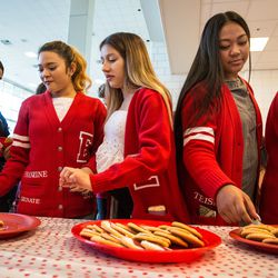 East High School students take some cookies during the opening of the school's expanded Leopard Stash food pantry in Salt Lake City on Tuesday, Nov. 20, 2018.