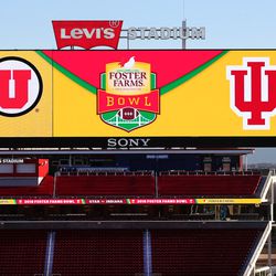 A large video screen shows the Utah Utes and the Indiana Hoosiers' logos as the teams prepare to play in the Foster Farms Bowl in Santa Clara, California, on Wednesday, Dec. 28, 2016.