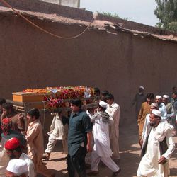 Pakistani villagers carry the body of a community police officer killed in an attack, for burial in suburbs of Peshawar, Pakistan on Tuesday, April 2, 2013. Several dozen militants armed with assault rifles and rocket-propelled grenades attacked a power grid station in northwestern Pakistan before dawn Tuesday, killing many people and taking hostages, police said. 