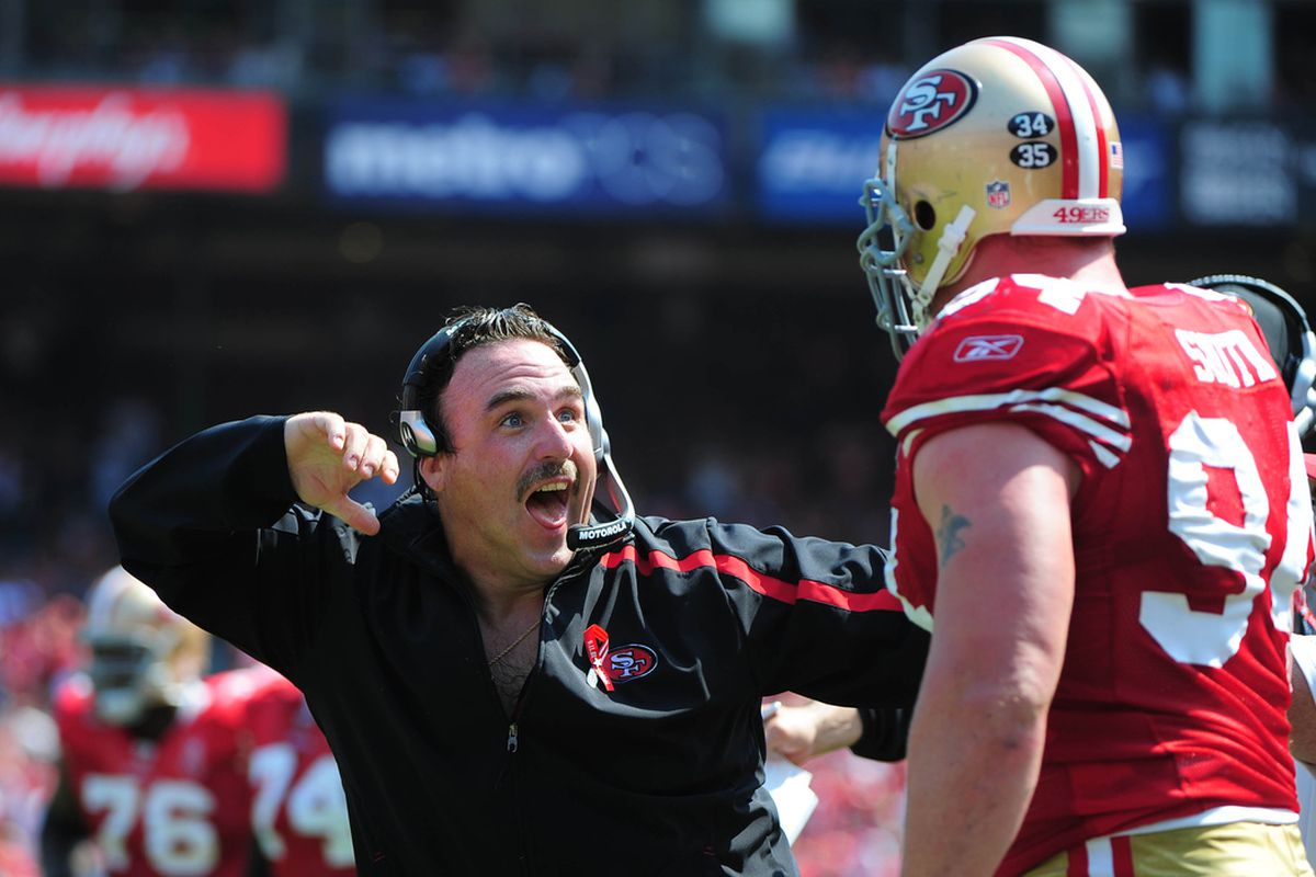 September 11, 2011; San Francisco, CA, USA; San Francisco 49ers defensive line coach Jim Tomsula (left) celebrates with defensive tackle Justin Smith (94) during the second quarter against the Seattle Seahawks at Candlestick Park. The 49ers defeated 