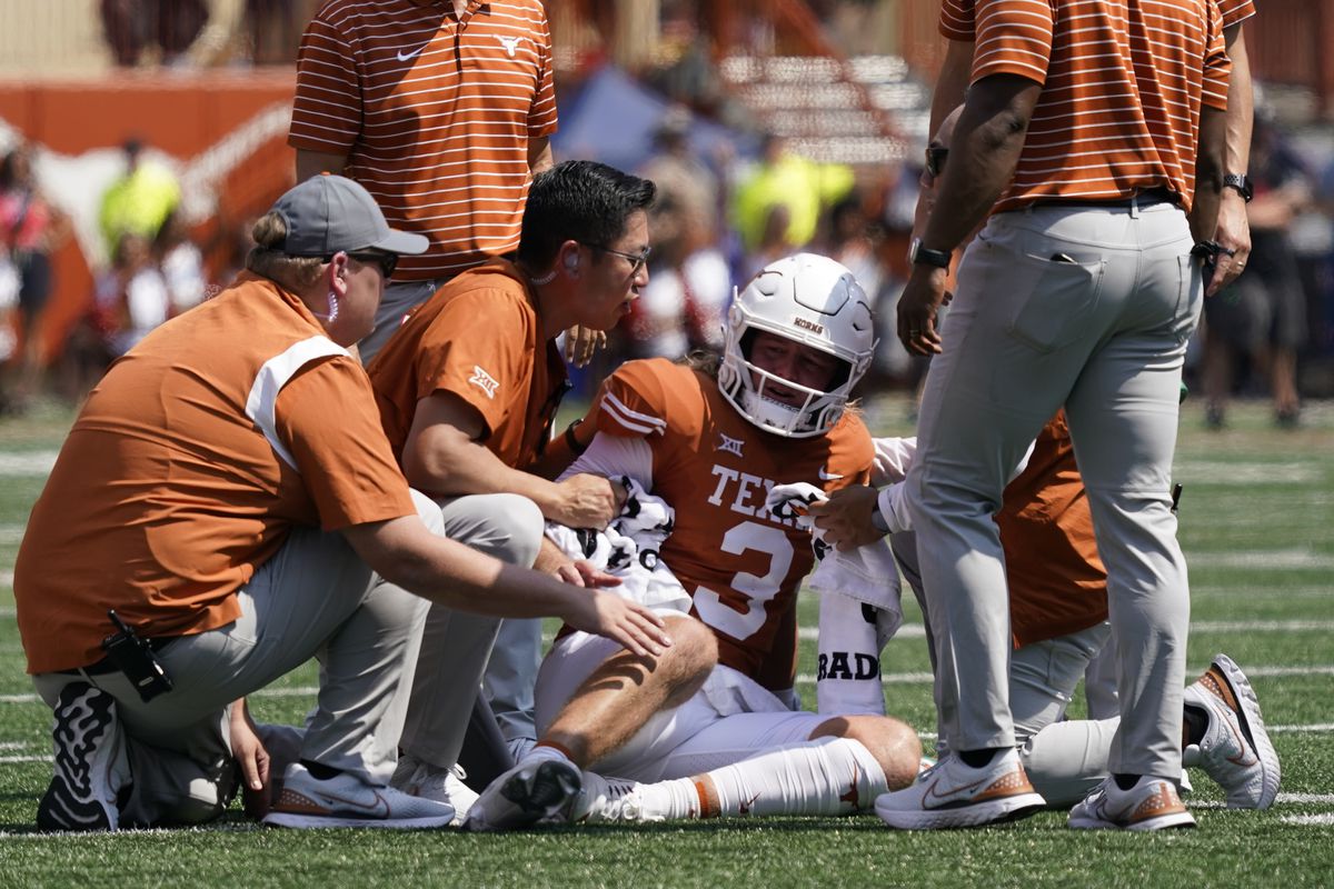 Texas Longhorns quarterback Quinn Ewers is attended to after getting hit while throwing a pass against the Alabama Crimson Tide during the first half at at Darrell K Royal-Texas Memorial Stadium.