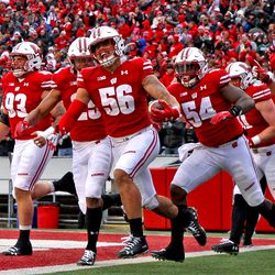 Zack Baun and his defensive teammates celebrate the fourth TD scored by the Badgers defense this season.