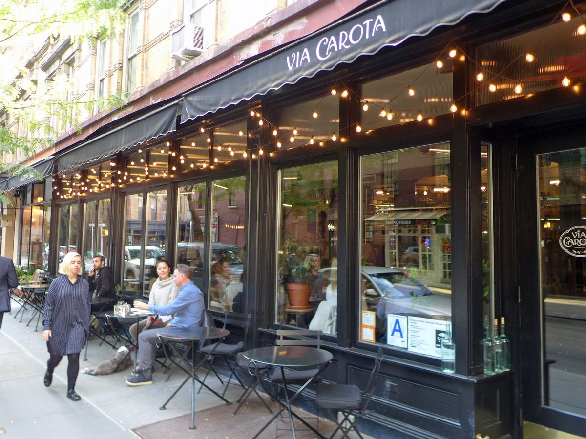 Via Carota West Village with sidewalk tables in front.