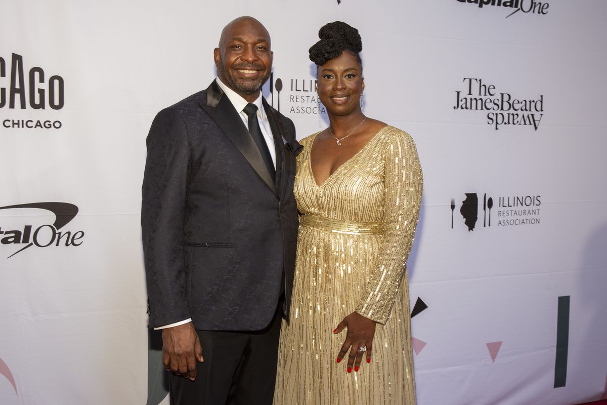 A Black man and woman pose on the James Beard Foundation Awards red carpet.