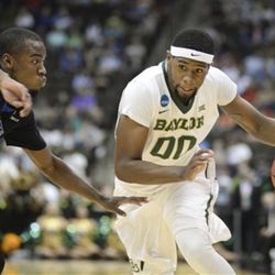 Baylor forward Royce O'Neale (00) drives past Georgia State guard Ryann Green (2) during the first half of an NCAA tournament second round college basketball game, Thursday, March 19, 2015, in Jacksonville, Fla.  (AP Photo/Rick Wilson)
