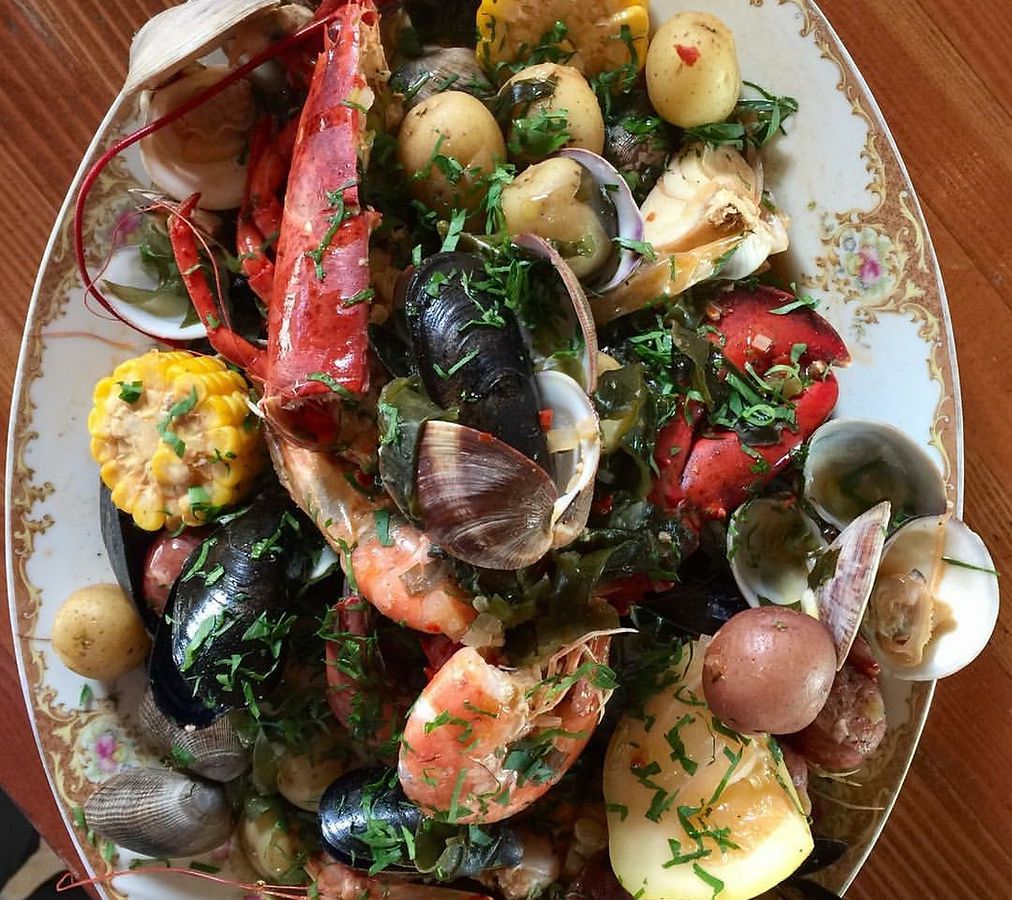 A platter of purloo — a generous pile of cobs of corn, mussels, shrimp, and other seafood.