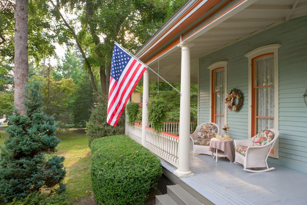 An American flag hangs from a Victorian home