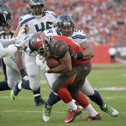 Tampa Bay Buccaneers running back Doug Martin (22) is tackled by Seattle Seahawks middle linebacker Bobby Wagner (54) after rushing for yardage during the first half of an NFL football game in Tampa, Fla., Sunday, Nov. 27, 2016. (AP Photo/Phelan M. Ebenhack)