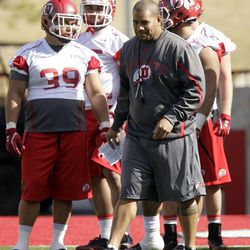 Former Utah assistant coach Ilaisa Tuiaki works with players  in the first spring football practice in Salt Lake City  Tuesday, March 20, 2012. 