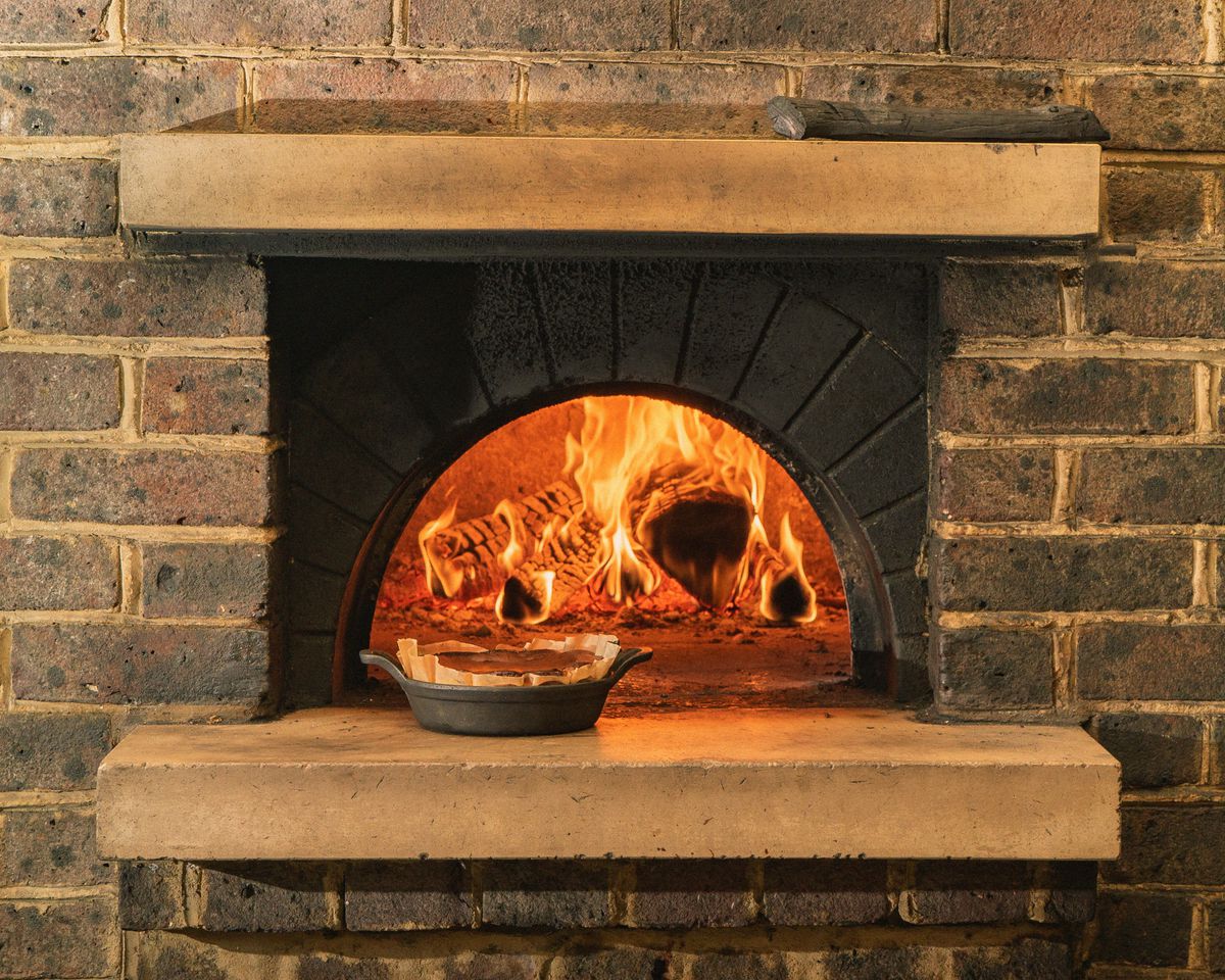Cheesecake in front of the wood oven at Brat, Eater London’s Restaurant of the Year