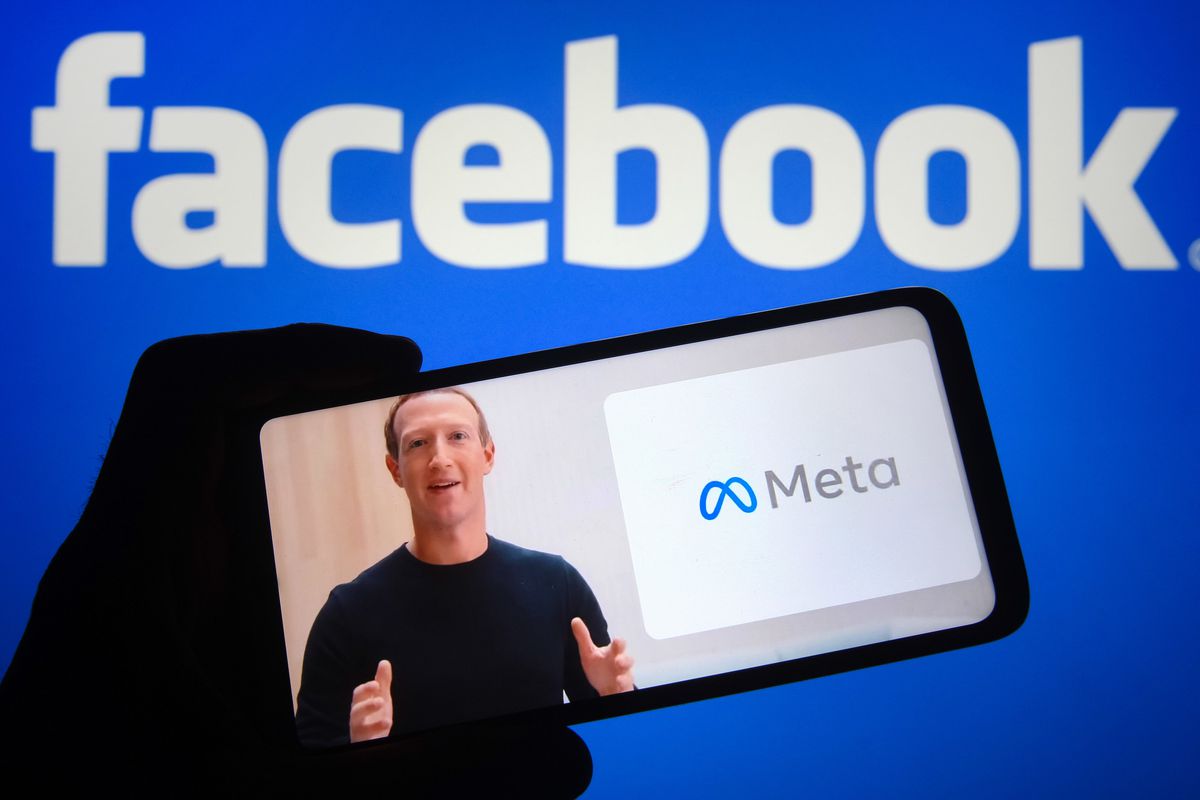 A photo illustration of Facebook CEO Mark Zuckerberg appearing on a phone screen announcing the company’s name change to Meta.