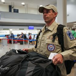 Barrett Raymond, a member of the Utah's Disaster Medical Assistance Team, carries his gear at the Salt Lake City International Airport on Tuesday, Aug. 29, 2017, before heading to Texas to help with Hurricane Harvey relief efforts. The 36-member team consists of physicians, nurses, paramedics, emergency medical technicians and other medical specialists.