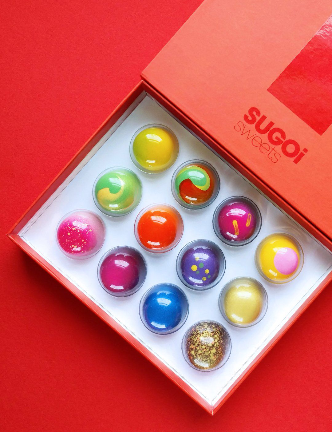 A red box filled with colorful bon bons.