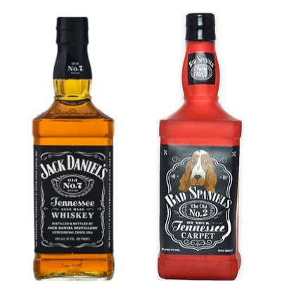 A side-by-side photo of a Jack Daniels whiskey bottle and a dog toy in the shape of the bottle, featuring similar design elements.