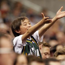 A young fan gestures his displeasure for a call in the second half of an NBA regular season game against the Golden State Warriors at the Vivint Arena in Salt Lake City, Wednesday, March 30, 2016.