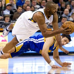 Utah center Boris Diaw (33) and Golden State center Zaza Pachulia (27) dive for a loose ball during the first half of an NBA basketball game in Salt Lake City on Thursday, Dec. 8, 2016.