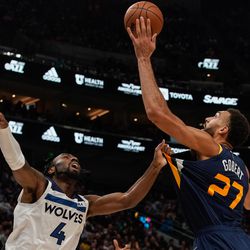 Utah Jazz center Rudy Gobert, right, shoots as Minnesota Timberwolves guard Jaylen Nowell attempts to defend during an NBA game at Vivint Arena in Salt Lake City on Thursday, Dec. 23, 2021.