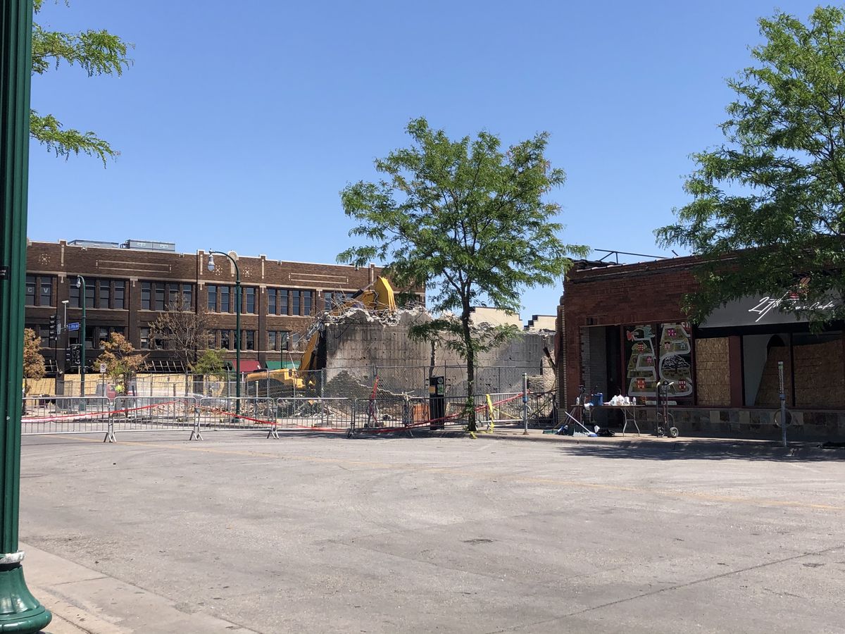 The street where the restaurant once was. A pile of rubble is being removed by a construction crew.