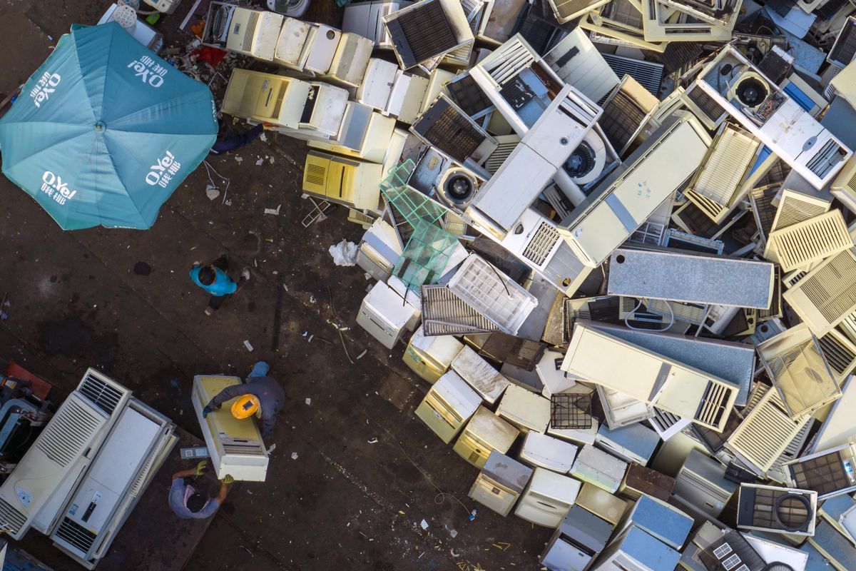 Workers sort recycled home appliances such as refrigerators, computers, and air conditioners to be disassembled at a recycling point for renewable resources in Huai ‘an, Jiangsu province, China, August 18, 2022.
