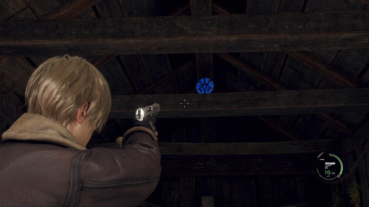 Leon S Kennedy aims at a blue medallion inside a barn of the Farm area in Resident Evil 4 remake