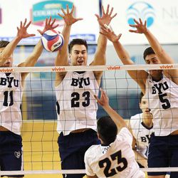BYU's Matt Underwood, Michael Hatch and Kiril Meretev work to block a spike by CBU's Rohit Paul as BYU and Cal Baptist University play Saturday, Feb. 7, 2015, at BYU in the Smith Field House in Provo.