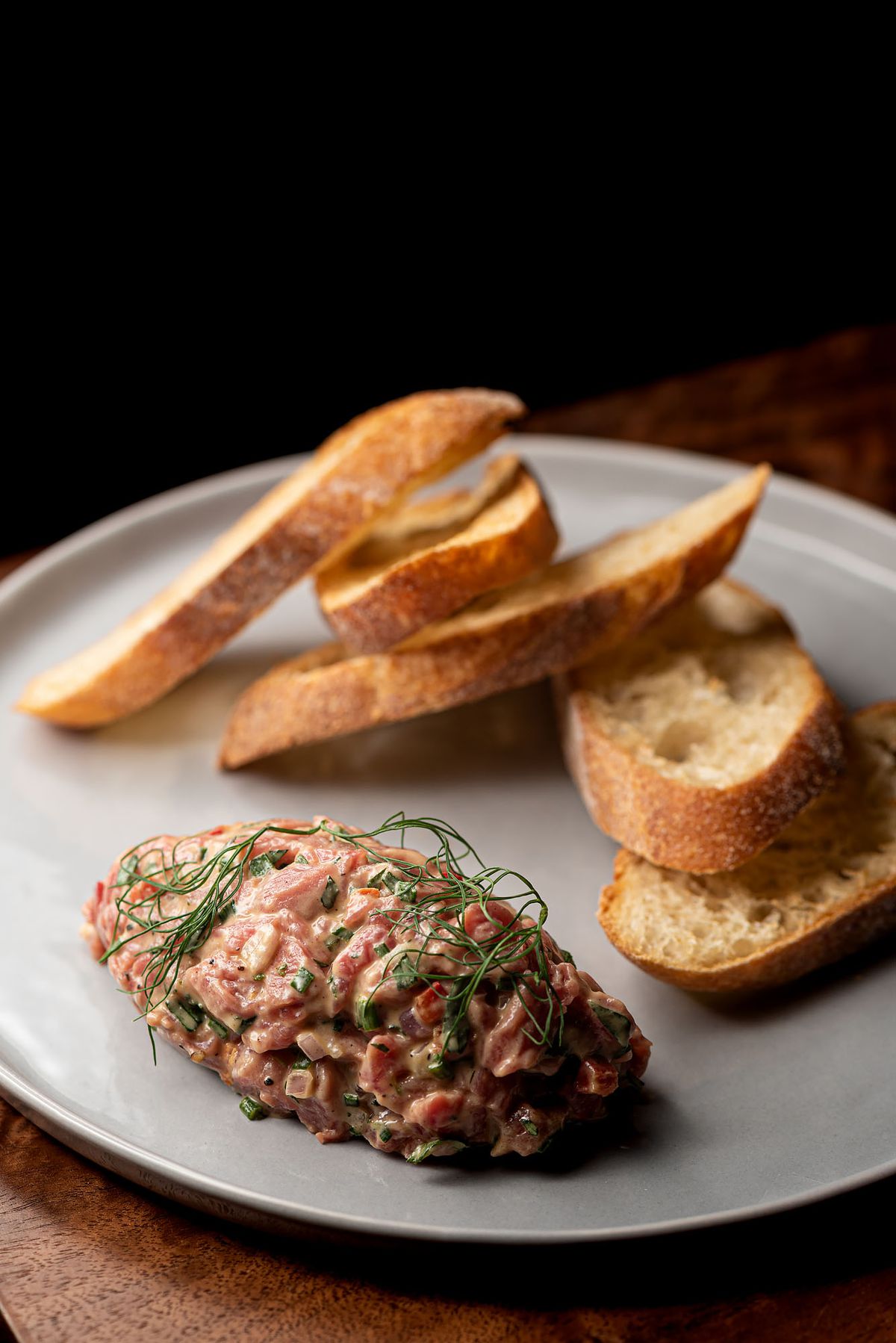 Beef tartare with slivers of baguette.