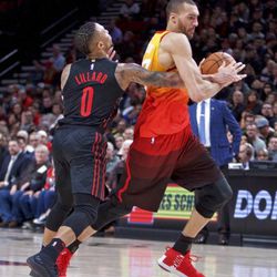 Utah Jazz center Rudy Gobert, right, is fouled by Portland Trail Blazers guard Damian Lillard during the second half of an NBA basketball game in Portland, Ore., Sunday, Feb. 11, 2018. (AP Photo/Craig Mitchelldyer)